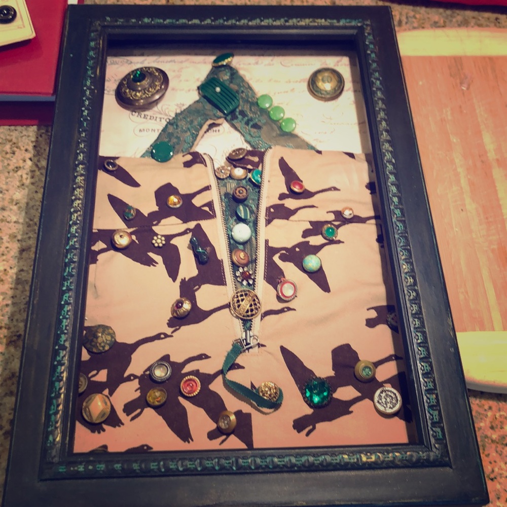 Shadowbox containing antique buttons lace & fabric